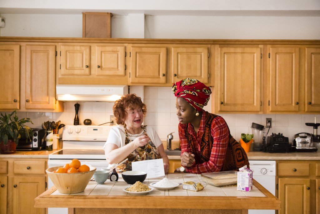 E-180 CEO Christine Renaud's mother teaching E-180's Epenge Kabasele how to make fudge. Photo by Jeremie Battaglia.